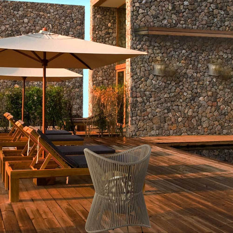 Polinesia outdoor wall light fabric shade IP44 in a modern outdoor area with a wooden deck and sun umbrellas.