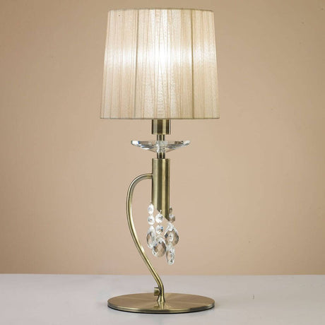 Elegante Tiffany Tischlampe mit metallischem Fuß und textilbezogenem Schirm, ideal für moderne Wohnräume.