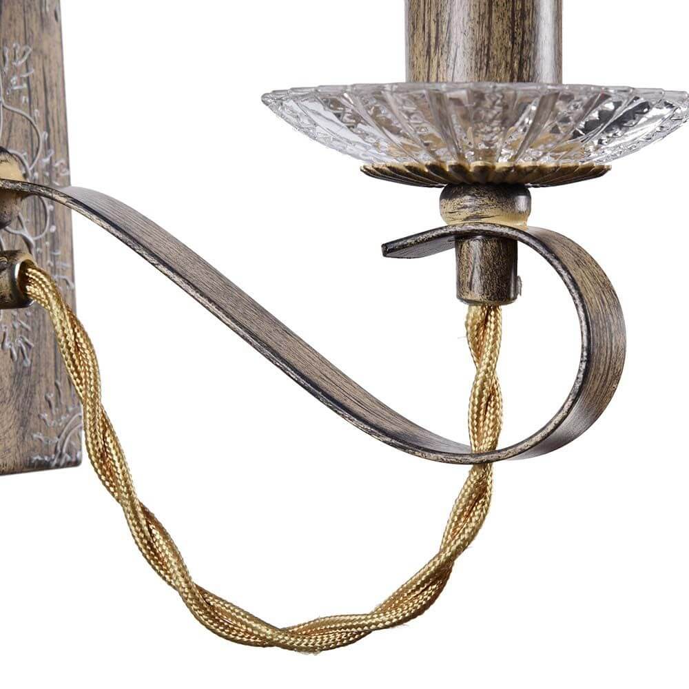 Cable Wandleuchte Braun mit filigranem Drahtmuster und transparentem Organza Lampenschirm.
