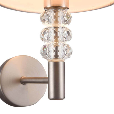 Lincoln wall light made of metal and fabric with a decorative glass element. Elegant design for contemporary interiors.