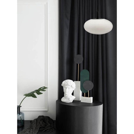 Perlas Pendelleuchte Ø 43cm in elegantem Raum mit schwarzem Vorhang und Dekoration.