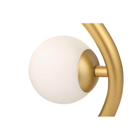 Detailansicht der Tischleuchte Uva mit mattiertem Glas und goldfarbenem Metallrahmen.