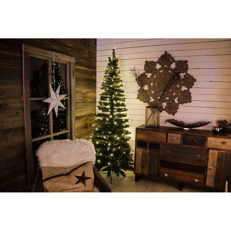Cozy Christmas decoration with a decorated tree and warm lights in a stylish interior.
