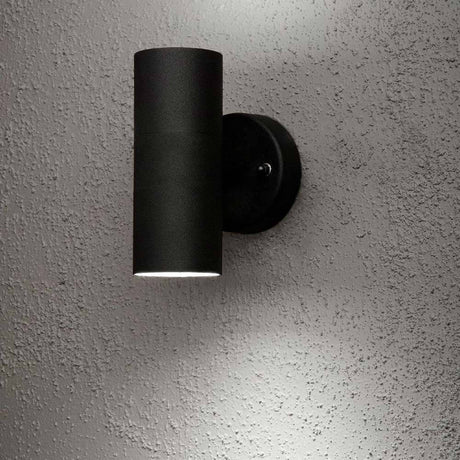 Modena outdoor wall light with double light beam, black, installed on the wall.