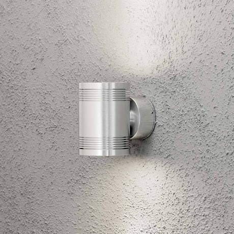 Monza LED outdoor wall light with double light beam mounted on a textured wall.
