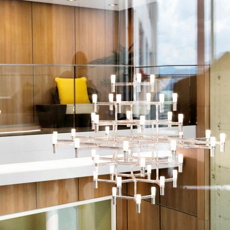 Nemo Crown Magnum chandelier 42-light Ø 160cm in a modern interior with wood panelling.
