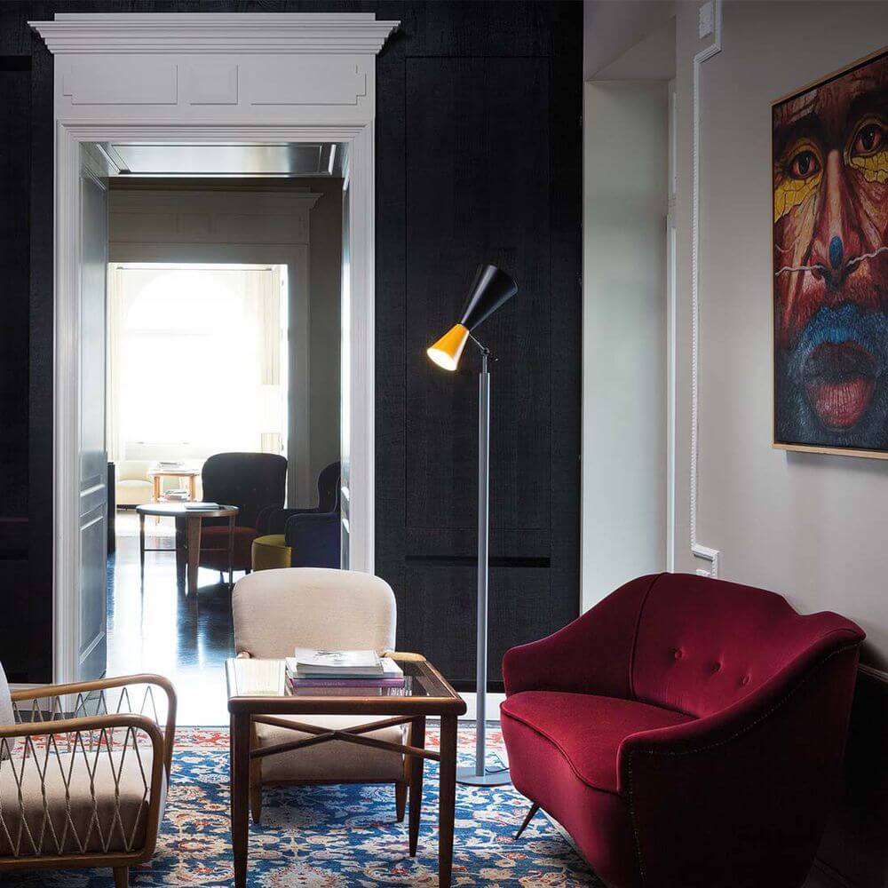 Moderne Stehlampe in stilvollem Wohnzimmer mit rotem Sessel und Kunstwerk an der Wand.