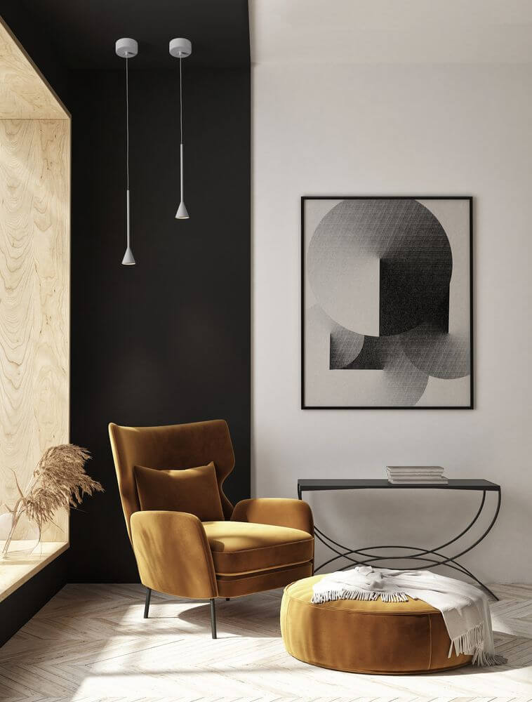 Net LED Pendelleuchte Ø 6cm 3000K über gemütlichem Lesesessel in modernem Wohnraum, matt schwarzes Aluminiumprofil, fokussierte Downlight-Beleuchtung
