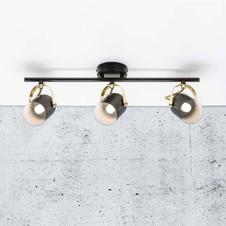 3er-Spot Lotus Schwarz, Messing an einer Decke mit schwarzem und poliertem Messing-Design.