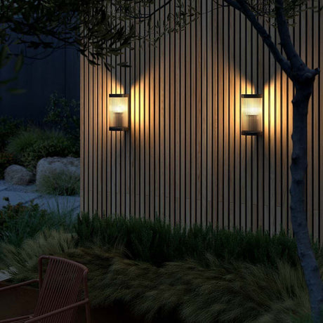 Coupar outdoor wall light on a wooden facade, soft lighting for modern outdoor areas.