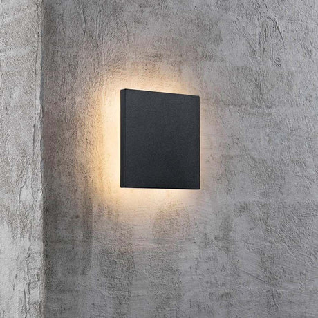 LED Artego IP54 Black outdoor wall light on a concrete wall with soft illumination
