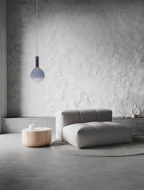 Nostos pendant light Ø 25cm 3000K above a modern sofa and table in a stylish room.
