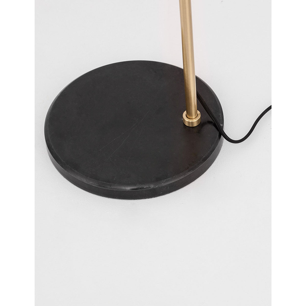 Nova Luce Alvarez floor lamp with round black marble base and golden metal stem, detailed view of the base