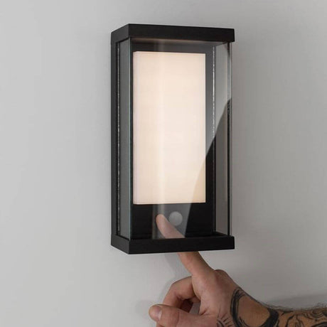 Bay wall solar light with motion sensor on the wall with warm white light and motion sensor activated.