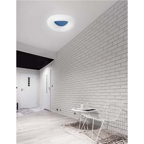 Cia LED acrylic ceiling light in a modern room with a white brick wall and designer chair.