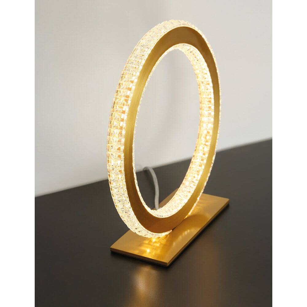 Cilion LED Tischlampe Ø 25cm Messing, Gold auf schwarzem Tisch mit modernem Design