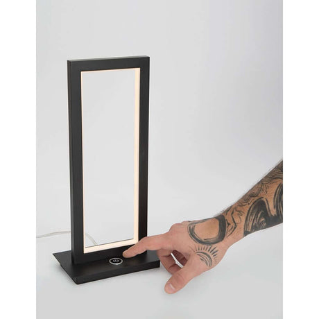 Cornice LED lampe de table noire avec commande tactile et design minimaliste.