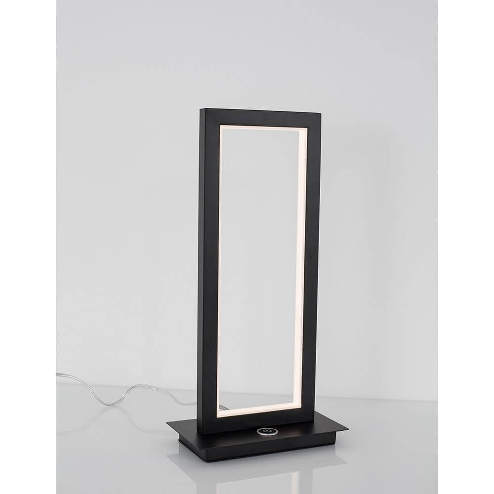 Cornice LED Tischlampe Schwarz auf einem Tisch, modernes Design mit eleganter Beleuchtung.