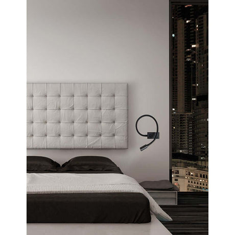 Nova Luce Geneva LED wall lamp next to a modern bed in an elegant bedroom setting.