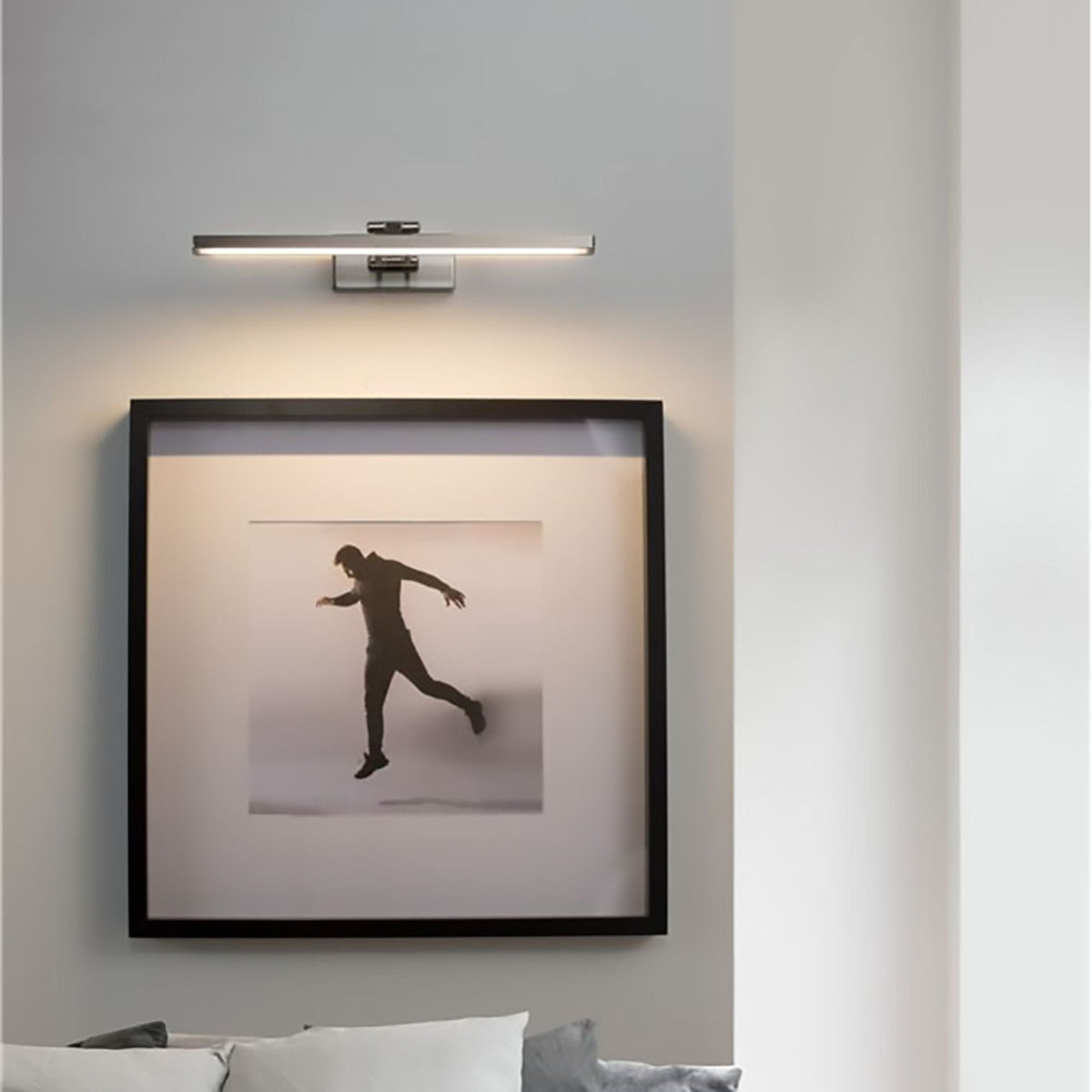 Nova Luce LED wall light Marnell silver, modern bathroom light mounted above picture frames on a white wall