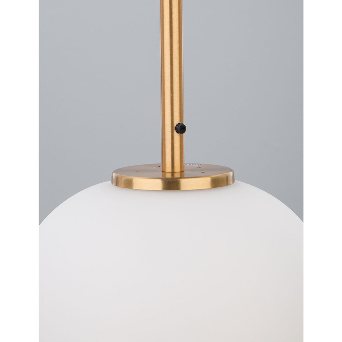 Nova Lace Lato pendant lamp with an opal-white glass sphere shade and brass mount, detail view