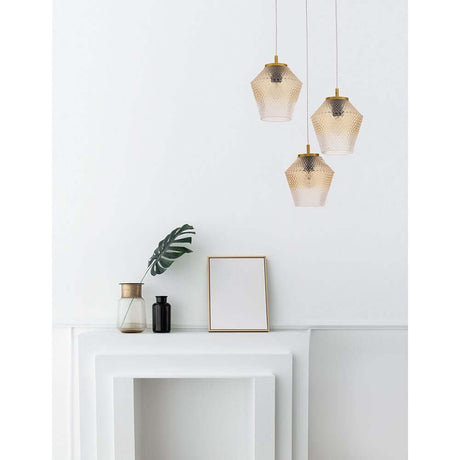 Magio Glas-Pendellampe 3-flammig Cognac über einem modernen Tisch mit Pflanzen und Dekoration.