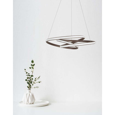 Menton LED pendant light with modern design, hanging above a table with plants.