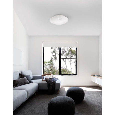 Elegant Sens bathroom ceiling light glass in a modern living environment with sofa and window.