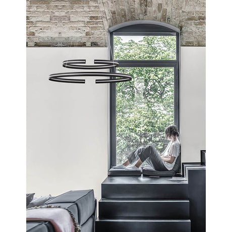 Torrente LED Hängelampe 3422lm Schwarz im modernen Wohnzimmer mit Person am Fenster.