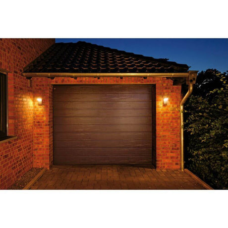 Ordi LED outdoor wall light 3000K anthracite lights up the garage door at dusk.