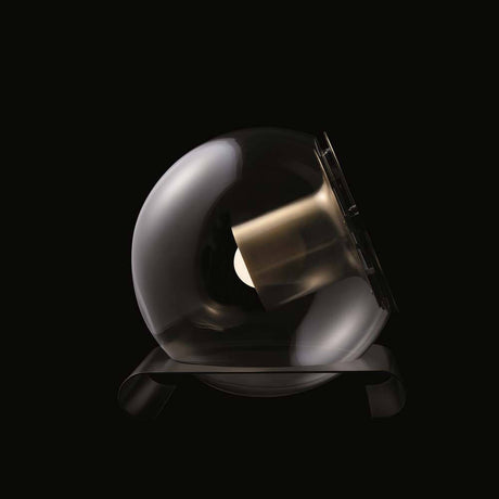 Oluce table lamp The Globe antique gold-coloured on a black background, elegantly designed table lamp.