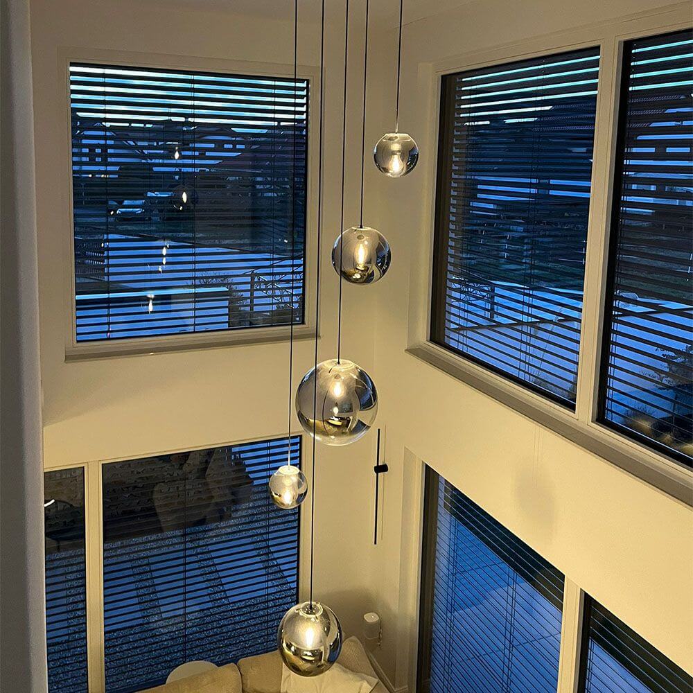 s.luce Orb Glaskugel Galerieleuchte Aufhängung 500cm Weiß in modernem Raum mit großen Fenstern.
