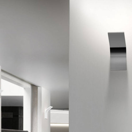 Panzeri App LED-lampada da parete a luce indiretta su una moderna parete bianca in uno spazio minimalista.
