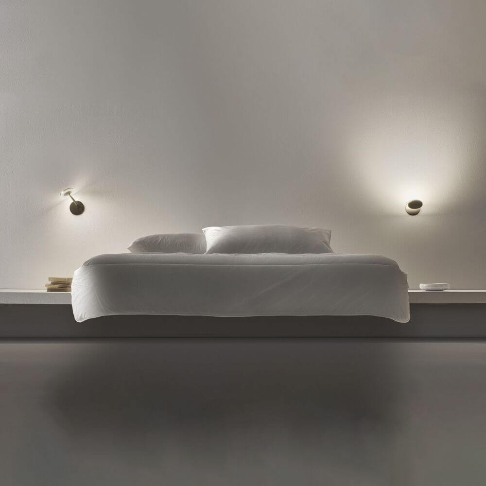Panzeri Bella built-in LED wall lamp touch switch next to a modern bed with minimalist design.