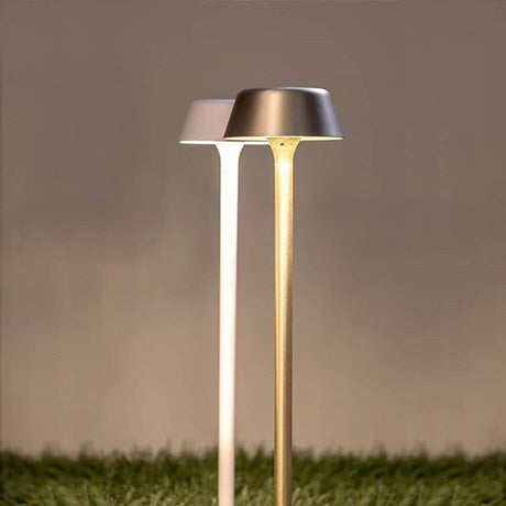 Panzeri Firefly in the Sky battery-powered light with ground spike, modern floor lights in white and gold on grass.