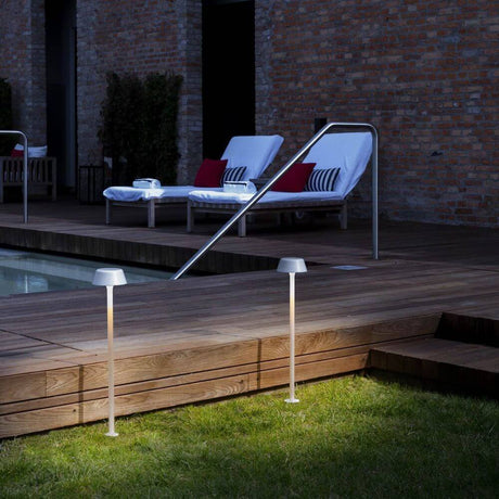 Panzeri Firefly in the Sky battery-powered light with ground spike in use beside a pool.