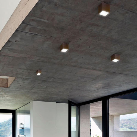 Panzeri Three LED ceiling light in cube form on the ceiling in a modern interior with direct light emission.