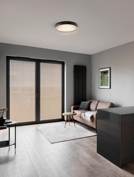 Modern apartment with Pauline LED ceiling light 3000K Black in the living room, soft lighting and stylish design.