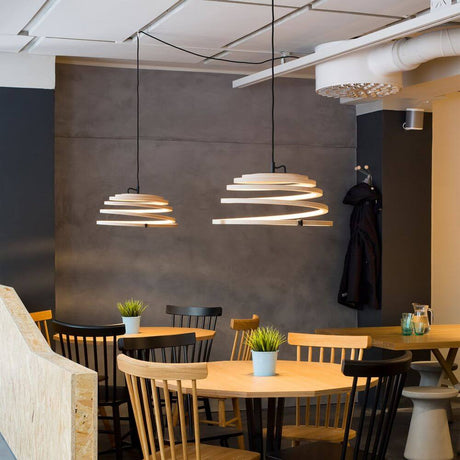 Aspiro 8000 pendant light made of wood Ø 50 cm above a table in a modern dining area.