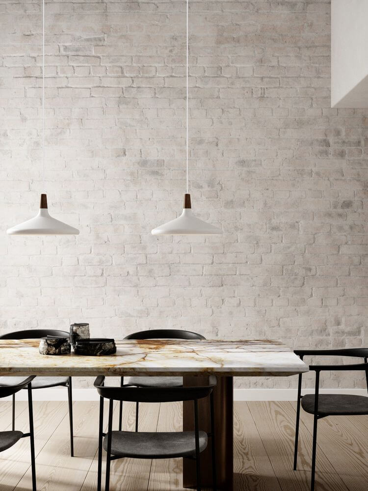 Pendelleuchte Nori 39 über einem minimalistischen Esstisch mit hellen Wänden und eleganten Stühlen.