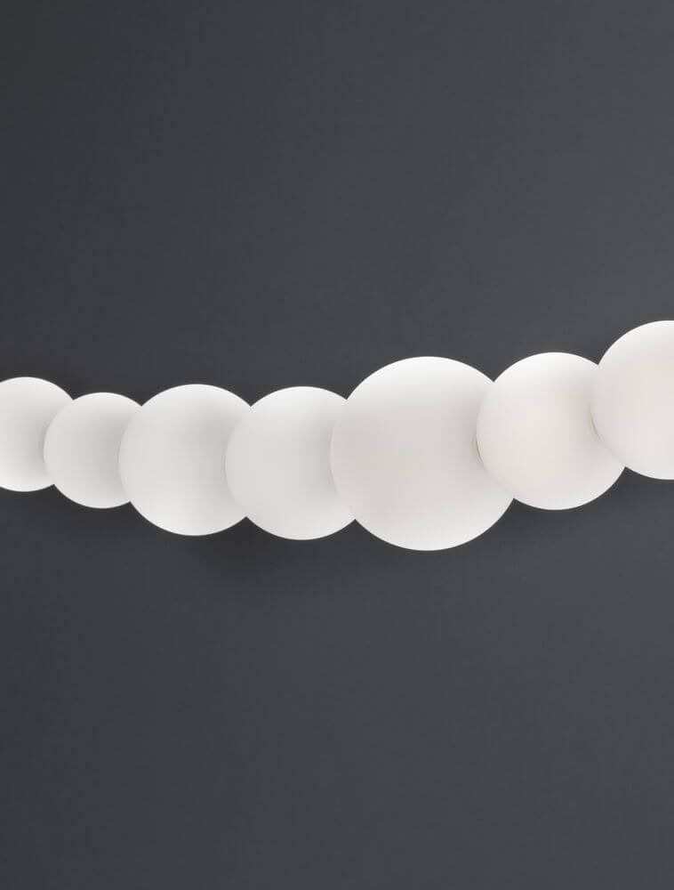 Perla LED Pendelleuchte Tiefbogen 13-flammig 3000K in elegantem Opalglas auf dunklem Hintergrund