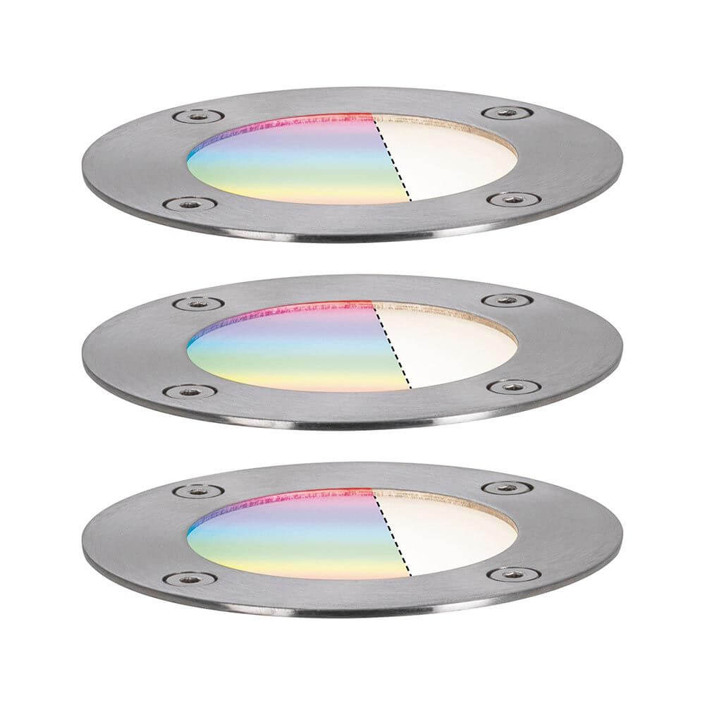 Drei runde Plug & Shine LED Bodeneinbaustrahler mit RGBW-Farbeffekten für Gartenbeleuchtung.