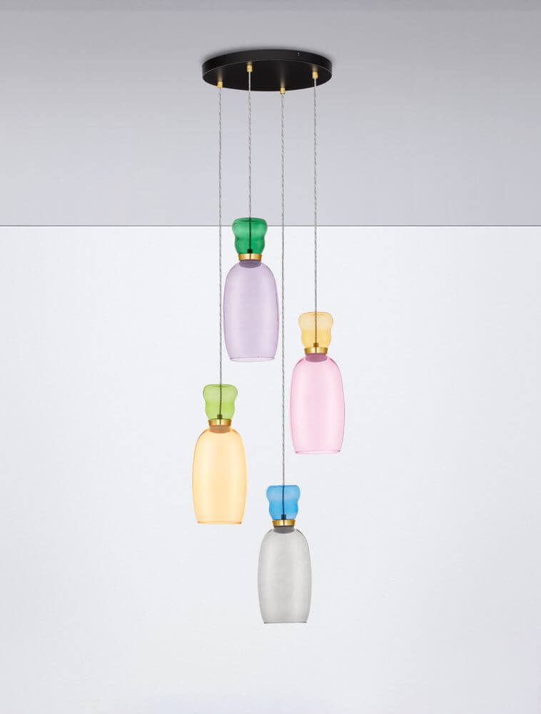 Pluma Pendelleuchte 4-flammig Ø 40cm 3000K Mehrfarbig mit bunten Glas-Elementen über einem Tisch hängend.