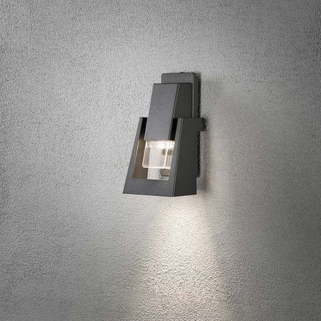 Potenza outdoor wall lamp anthracite IP54 on a wall, elegant and modern with warm light.