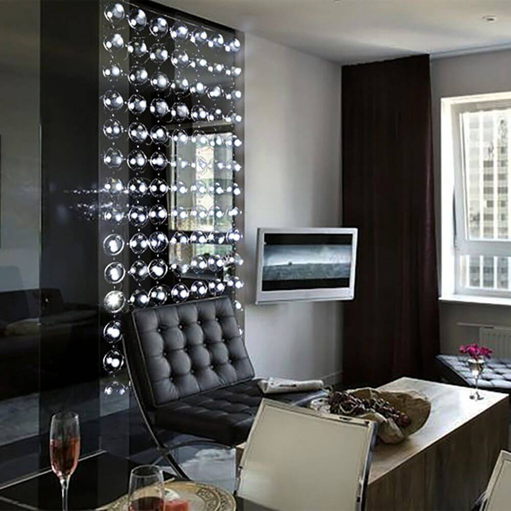 Bubbles Design Hängeleuchte 190 als eleganter Raumteiler in modernem Wohnzimmer mit stilvollem Ambiente.