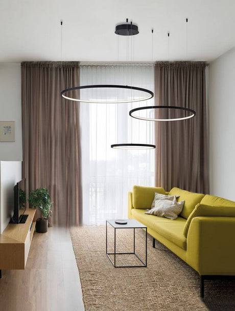 Purple LED 3-light pendant light Ø 130 cm 3000K above a modern yellow sofa in the living room.