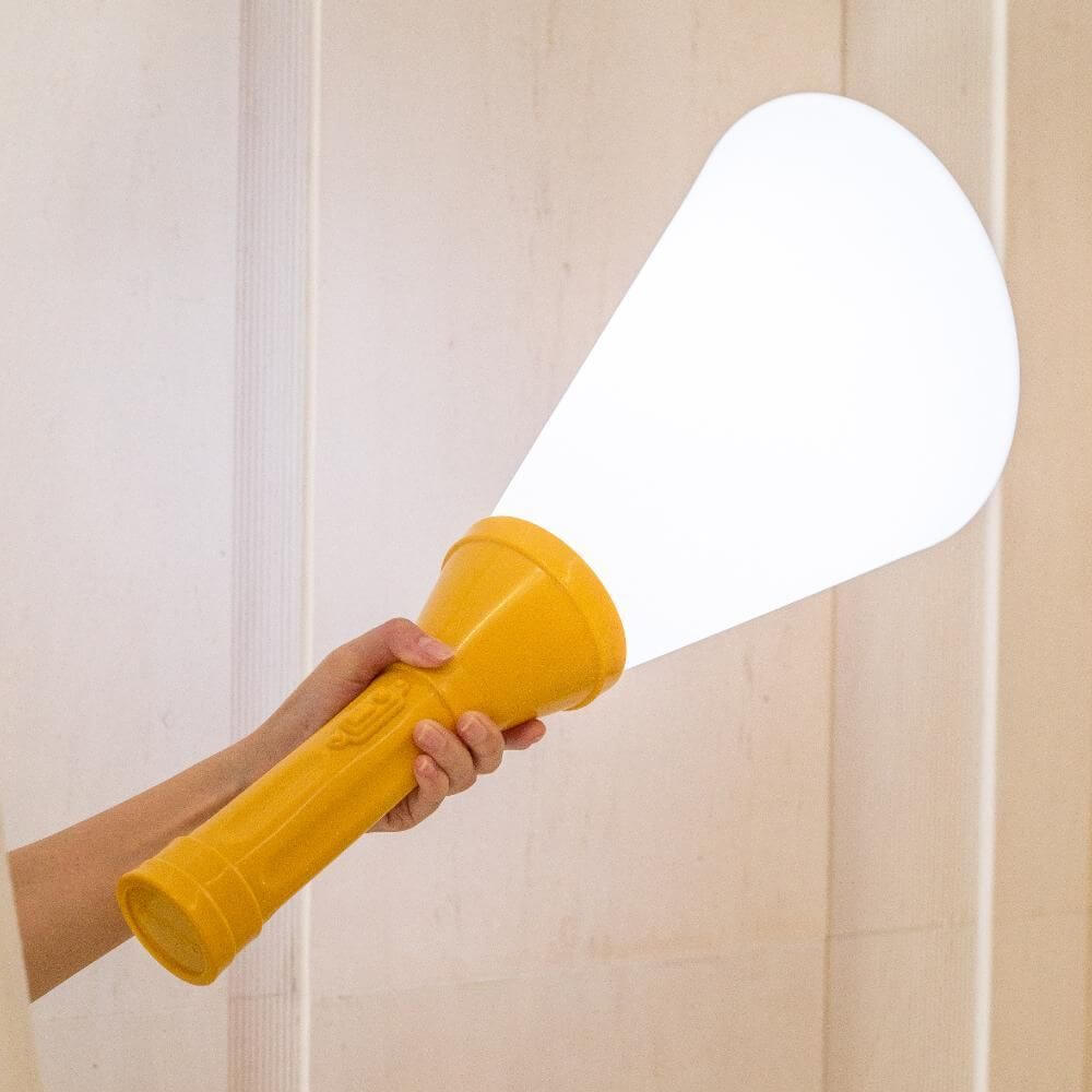 Flash Metall Akku Tischlampe mit Fernbedienung in Form einer Taschenlampe, die Licht strahlt.