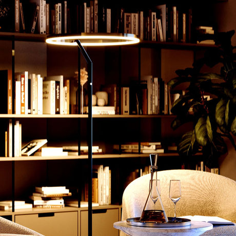s.luce Ring LED floor lamp Ø 60cm with touch dimmer in the modern living room while reading.
