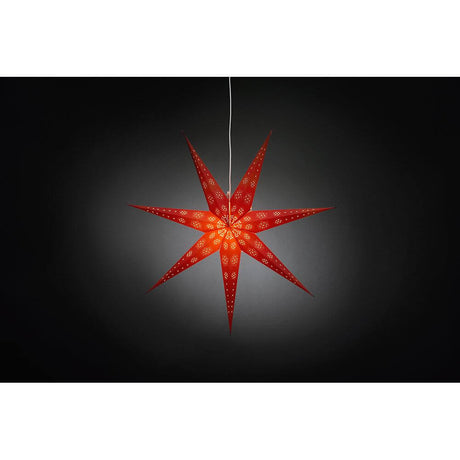 Red paper star, perforated with a white printed pattern, 7 points, without light source, against a dark background.
