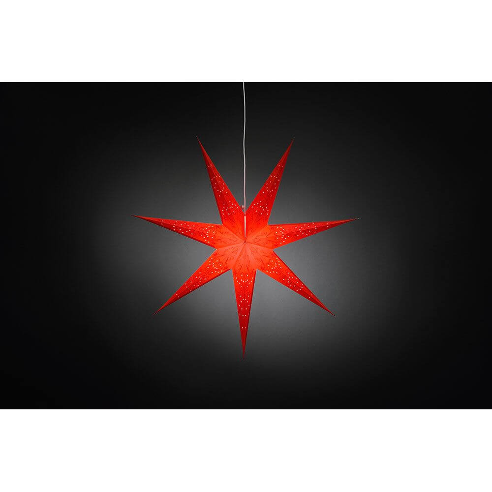 Roter Papierstern perforiert und rot bestickt 7 Zacken ohne Leuchtmittel, hängend vor dunklem Hintergrund.
